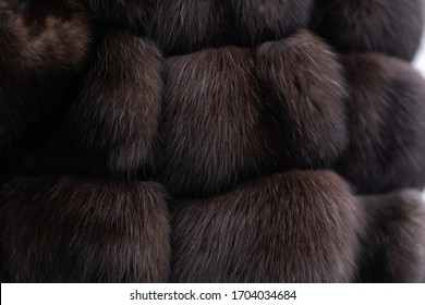 Fur texture close up. Woman in fur coat. Grey background. texture. Mink fur. mink coat. photo studio. Elegant outfit. Fashionable girl. Female fashion concept. City lifestyle. fur coat. no face