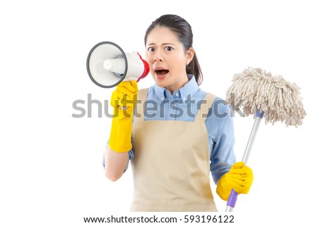 furious angry mad young woman using loud megaphone to announce her child to cleanup of the mess with holding a mop. isolated on white background. mixed race asian chinese model.