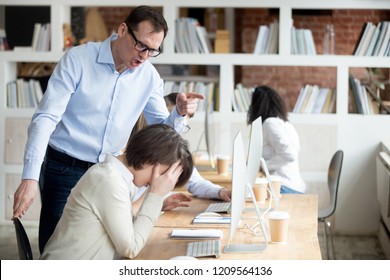 Furious businessman shout at female employee working in shared office, mad male boss scream at guilty intern, blaming for mistake, CEO accuse woman worker in company failure or bad results