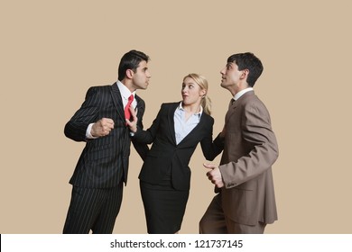 Furious Businessmen In Conflict With Woman Trying To Resolve Over Colored Background