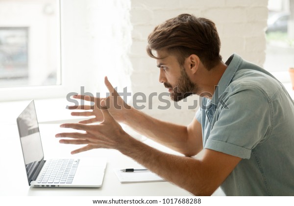 Furious man angry about bad news online or pc\
software failure, mad helpless office worker having problem with\
broken laptop, stressed student hates computer crash, user\
indignant about data\
loss