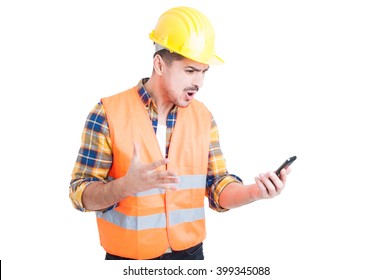 Furious Young Constructor Yelling And Showing Rage While Looking At His Mobile Phone Because Of A Problem On White Background