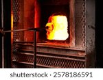 Furnace, heat and rod for melting glass in forge or foundry to shape industrial material into product. Art, craftsmanship and creative with fire in factory, plant or workshop for manufacturing