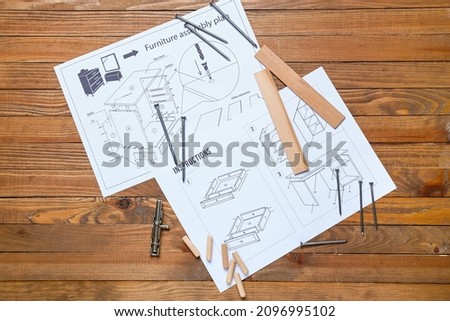 Furniture assembling plan, instructions and tools on wooden background