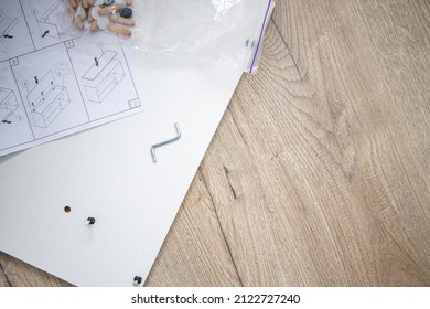 Furniture Assembly, Furniture Assembly Instructions On A Wooden Background. Top View, Flat Lay