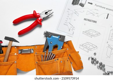 Furniture Assembly Instructions And Tools On White Background, Closeup