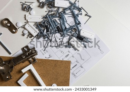 Furniture fittings. Furniture assembly hardware options and tools on a white background.