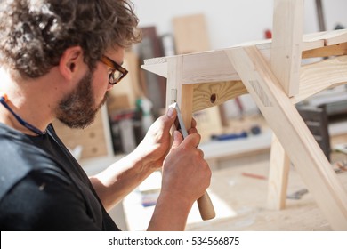  Furniture Maker Chiselling A Chair Joint In His Workshop