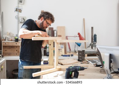  Furniture Maker Chiselling A Chair Joint In His Workshop