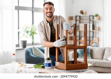 Furniture Renovation, Diy And Home Improvement Concept - Happy Smiling Man Sanding Old Wooden Table Or Chair With Sponge