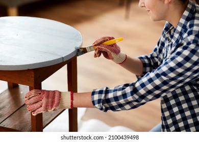 Furniture Renovation, Diy And Home Improvement Concept - Close Up Of Woman In Gloves With Paint Brush Painting Old Wooden Table In Grey Color