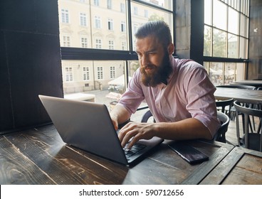 A Furrowed Brow Man Working With The Computer