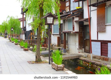 FURUKAWA, JAPAN. Old Houses From Edo Period, Japanese Lanterns, Trees, Plants And Carps In River, Charming Street. Village With Mainly Elderly Inhabitants And Aging Population, Hida, Gifu Prefecture