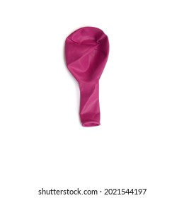 Fuschia Pink Deflated Balloon In A White Background