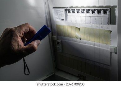 Fuse Box With Fuses In A Distribution Box During A Power Outage Illuminated With Blue Flashlight Held By A Man, Germany