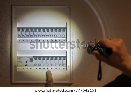 Fuse box illuminated with a flashlight in case of power failure 商業照片 © 