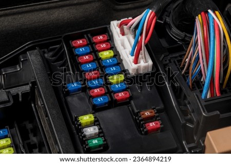 Fuse panel under the hood of vehicle. Automobile electrical repair, service and maintenance concept