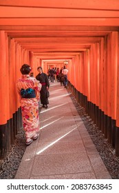 Fushimi Inari, Kyoto, Japan -November 5, 2018: People in traditional dress visit Senbon Torii (Thousands Torii Gates) at Fushimi Inari Taisha, the Shinto shrine located in Fushimi-Ku, Kyoto, Japan. 
