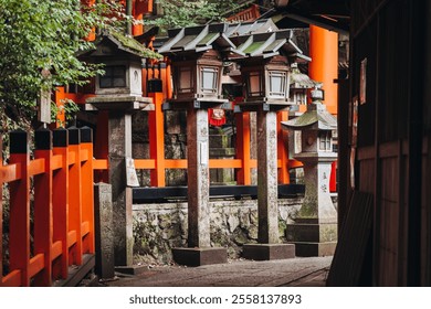 Fushimi Inari Taisha Shrine, Fushimi-ku, Kyoto Prefecture, Kansai region, Kyoto, Japan, Shinto shrine, mountain way with red torii gates tunnel, wooden torii path, fox sculptures, travel to Japan - Powered by Shutterstock