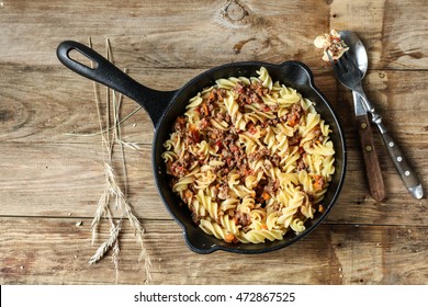 Fusilli Pasta with Bolognese Sauce on a Cast Iron Skillet. Rustic style, top  view