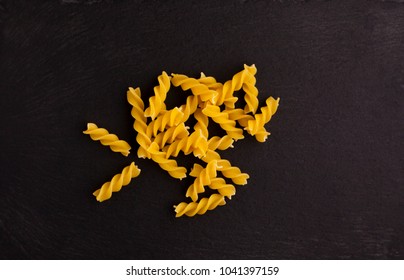 Fusilli Pasta On Black Slate Base. Image Shot Top Down.