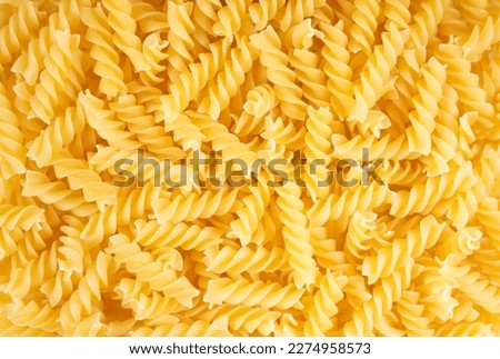 Fusilli spaghetti pattern, food background. Raw pasta, ingredient for cook, traditonal italian cuisine. Wallpaper, banner, header, backdrop for restaurant menu