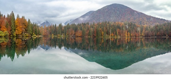 Fusini inferior lake with colorful boats in the shore, Julian alps, Italy - Shutterstock ID 2219922605