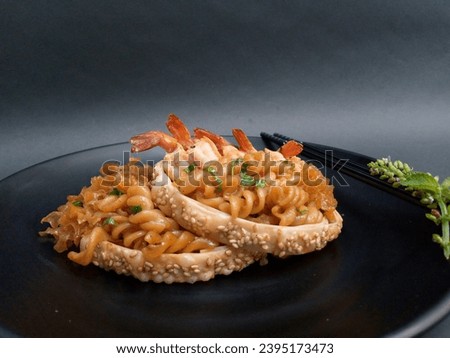 Fusion food, macaroni pasta with snow mushrooms and shrimp, cooked with Asian spices