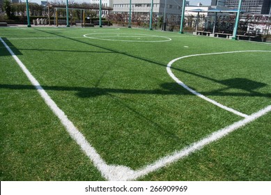Futsal court in a public outdoor park with artificial turf
