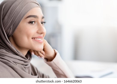 Future Business Leader. Closeup Portrait Of Smiling Arabic Woman In Hijab Resting Head On Hand And Looking Away, Selective Focus, Cropped, Copy Space