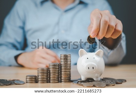 Future concept, saving coins on piggy bank and family, icons on the table, donating charity savings, financial planning concepts for families, finance, pension funds, investments and financial crises. Foto stock © 