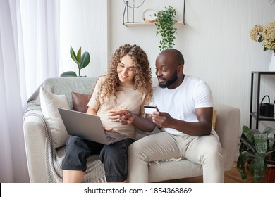 The Future Daddy Helps The Pregnant Wife To Choose A Baby Carriage For The Future Child By Paying By Credit Card. Parenthood, Money, Technology Concept.