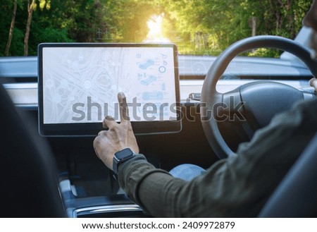 A future dashboard houses the autonomous control system of a driverless car. View from the inside of the cockpit of a car that uses artificial intelligence sensors to drive itself without a man driver