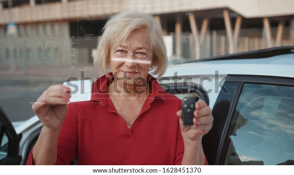 Future. Face Detection. Technological 3d\
Scanning. Biometric Facial Recognition. Face Id. Technological\
Scanning of the Face of Handsome Caucasian Senior Woman In The Car\
for Facial Recognition