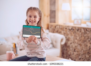 Future Financier. Positive Smart Girl Smiling While Using A Banking App