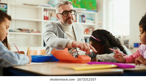 Future, learning or study with students and teacher at desk in classroom for child development. Education, growth or teaching with educator man and kids in elementary school class for lesson