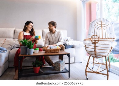 Future parents with pregnant woman preparing baby things at home - Powered by Shutterstock