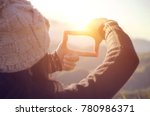 Future planning, Close up of woman hands making frame gesture with sunrise on mountain, Female capturing the sunrise, sunlight outdoor.