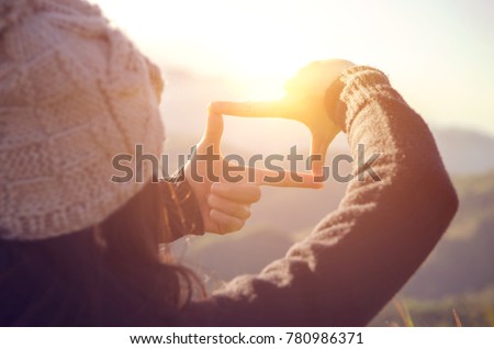 Future planning, Close up of woman hands making frame gesture with sunrise on mountain, Female capturing the sunrise, sunlight outdoor.