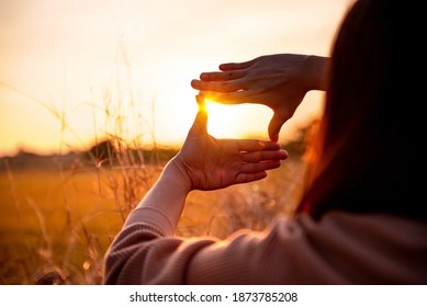 Future planning concept, Close up of woman hands making frame gesture with sunset, Female capturing the sunrise. - Shutterstock ID 1873785208