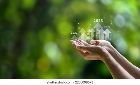 Future planning goals and new visions for the year 2023. Businessman background green environment. with arrow icon increasing future company growth 2023 to 2024 planning opportunities challenges - Shutterstock ID 2235098693
