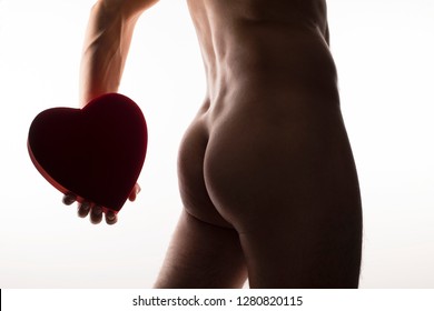 Future Of Sex, Man Holding A Red Velvet Heart Shaped Box Behind His Back. Slim Naked Male Ass