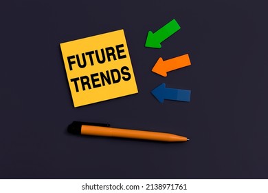 Future Trends - Concept Of Text On Sticky Note. Concept Of Newest, Latest, Hot And Popular Future Trends. Orange Square Sticky Note, Pen And Colorful Arrows On Dark Blue Background, Top View