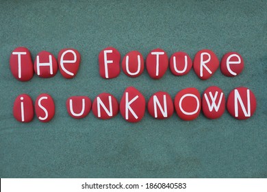 The future is unknown, creative slogan composed with red colored stone letters over green sand