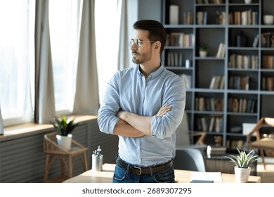 Future vision and forward thinking. Pensive young man business professional entrepreneur ceo stand in office workplace with arms crossed visualize big project success plan long term strategy set goals