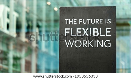 The future of work is Flexible sign in front of a modern office building
