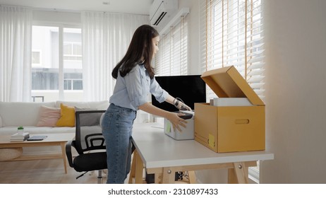 Future of workforce remote work fully permanent. Asia people happy relax move job to new small workspace set up desk picking file folder from box. Keep it chores neat start long term plan career work. - Shutterstock ID 2310897433