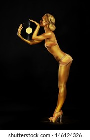 Futurism. Shapely Golden Woman DJ with Vinyl Record. Body Painting