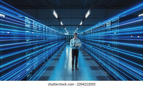 Futuristic 3D Concept: Big Data Center Chief Technology Officer Holding Laptop Standing In Warehouse, Information Digitalization Lines Streaming Through Servers. SAAS, Cloud Computing, Online Service - Powered by Shutterstock