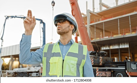 Futuristic Architectural Engineer Wearing Augmented Reality Headset and Using Gestures to Control Commercial Building Construction Site. In Background Skyscraper Formwork Frames and Industrial Crane - Powered by Shutterstock